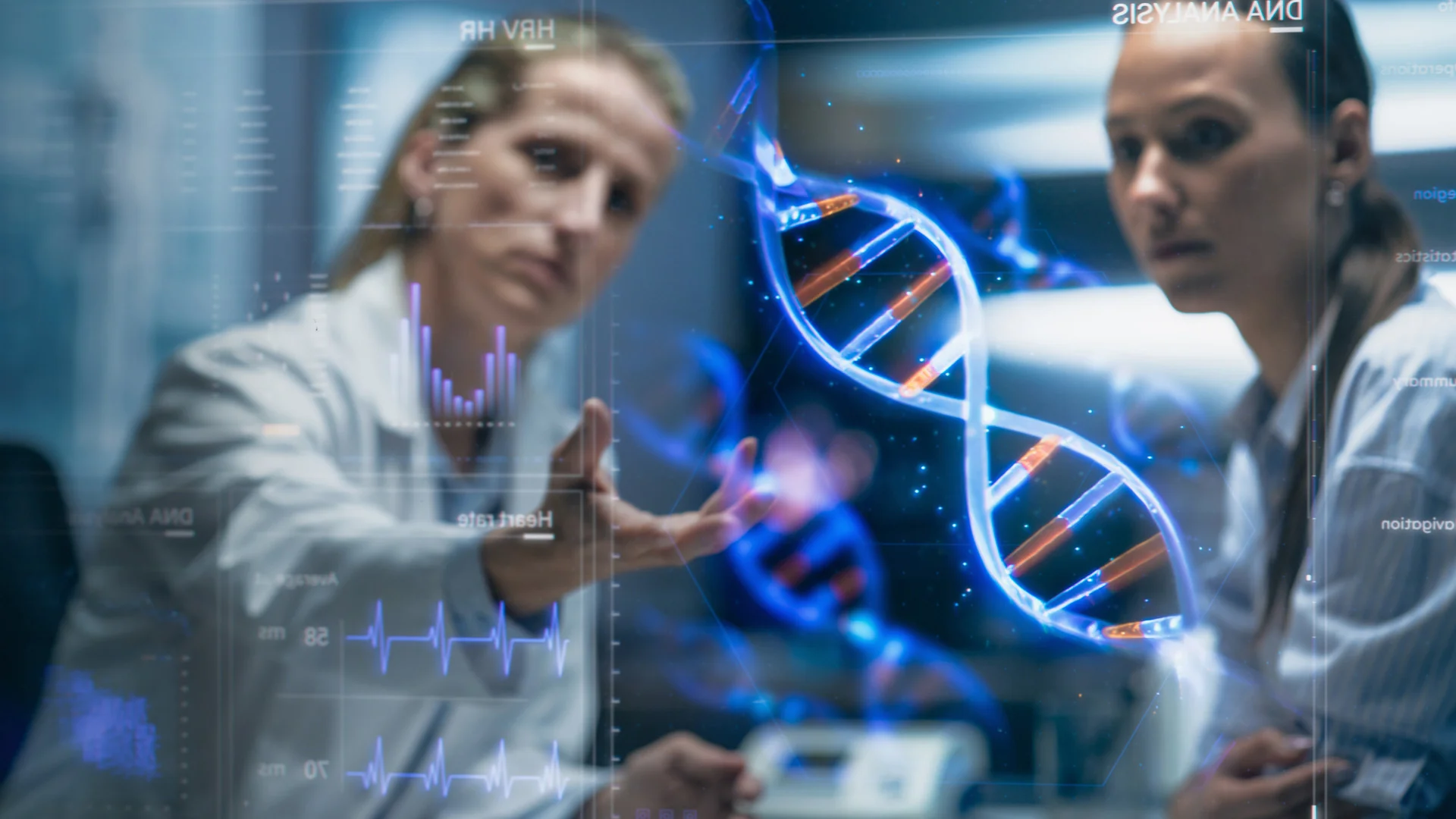 Two scientists looking at a graphic of DNA