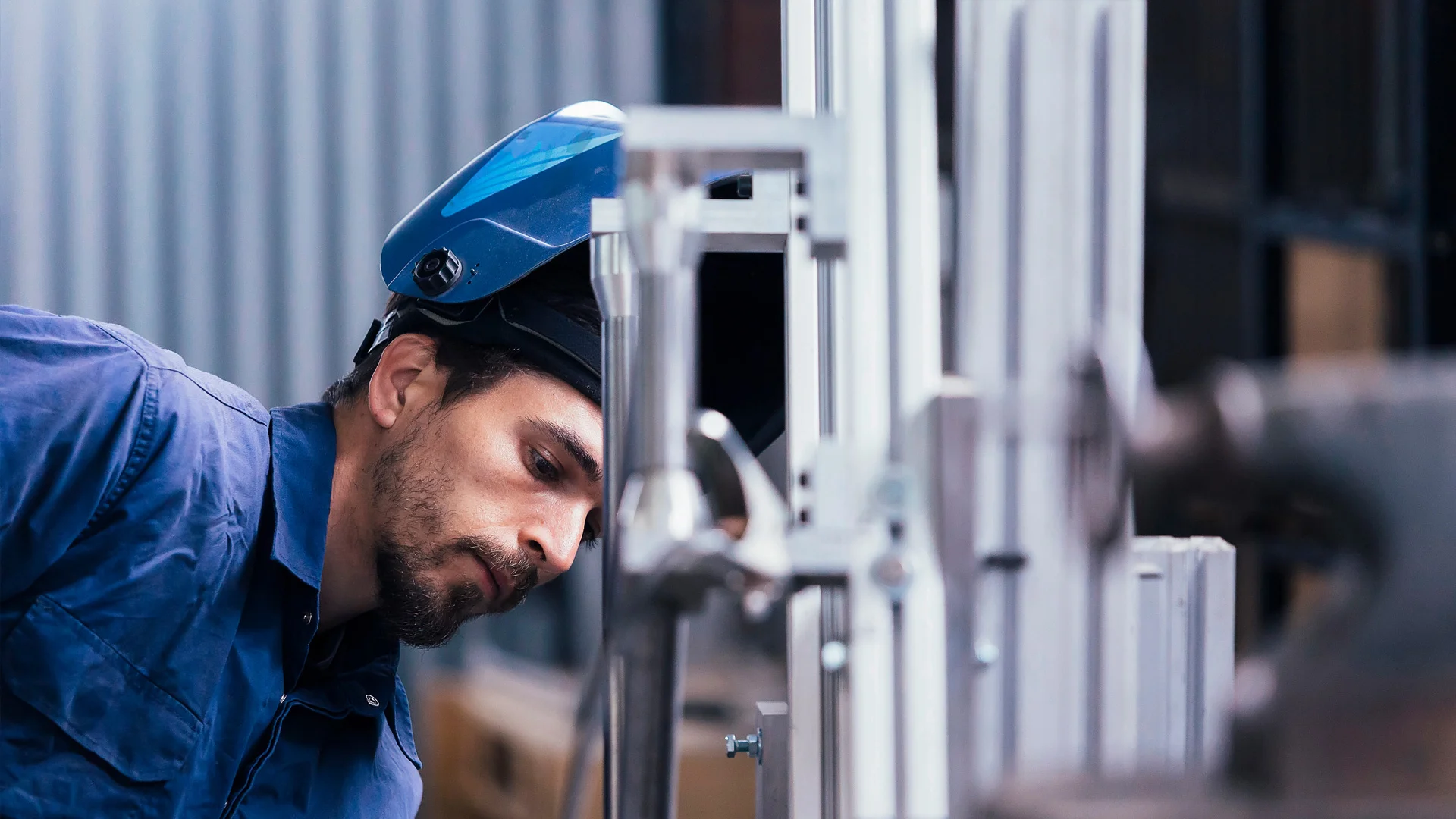 Man with protective headgear working with machinery