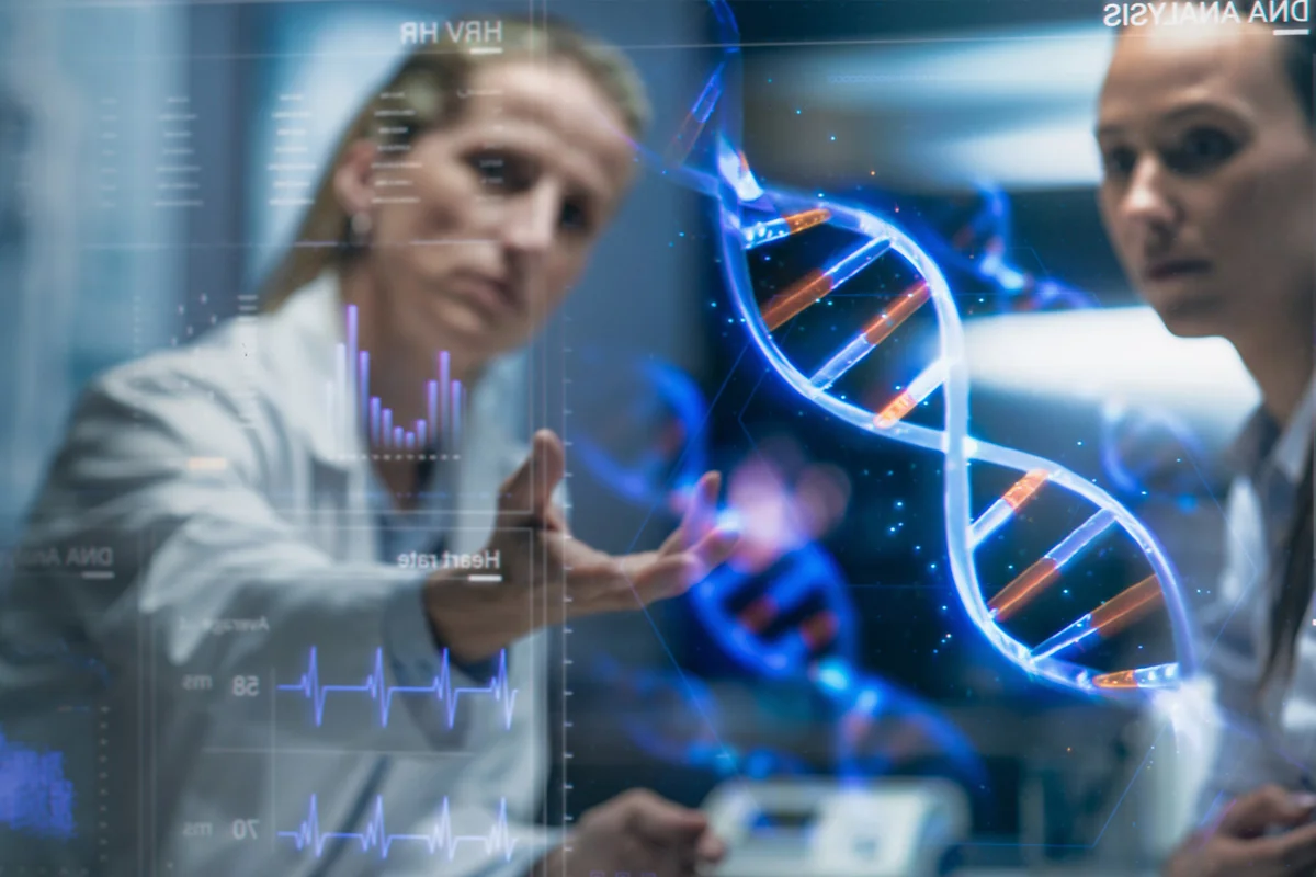 Two scientists looking at a graphic of DNA