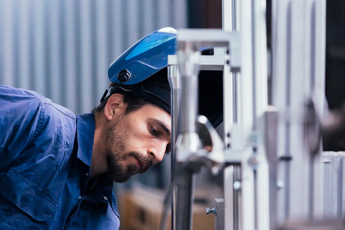 Man with protective headgear working with machinery