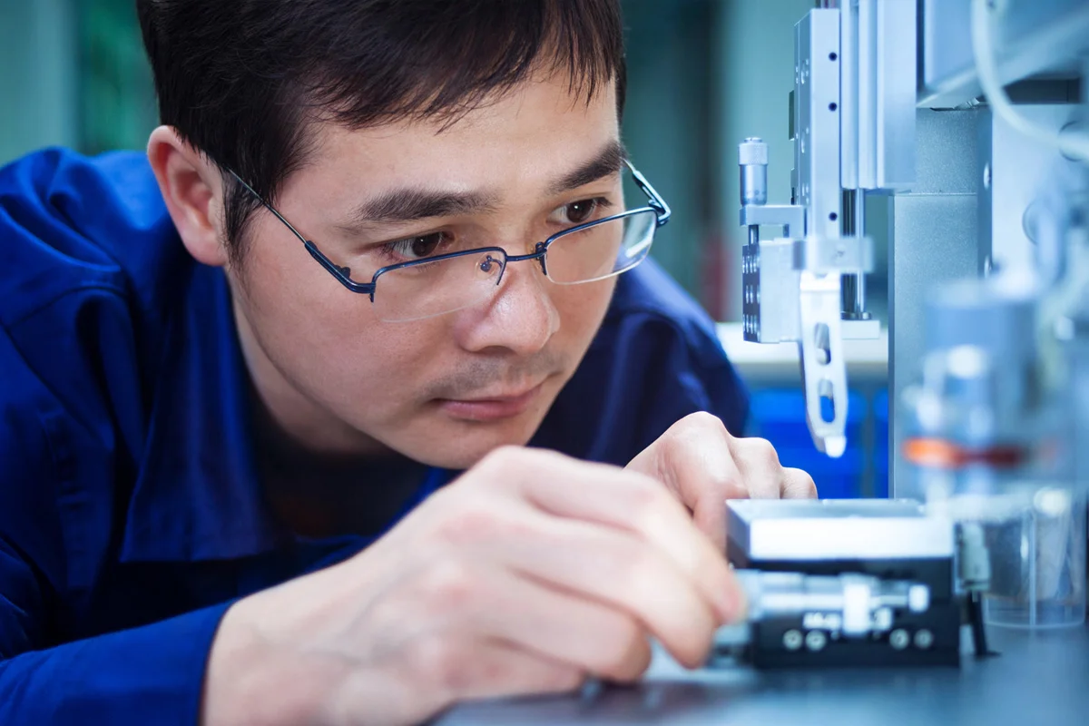 Man in glasses working with machinery