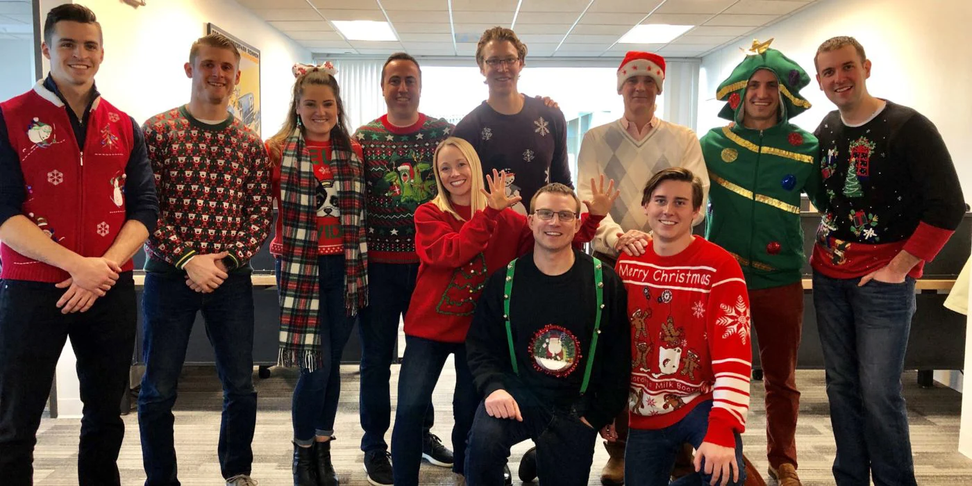 Team posing in christmas jumpers